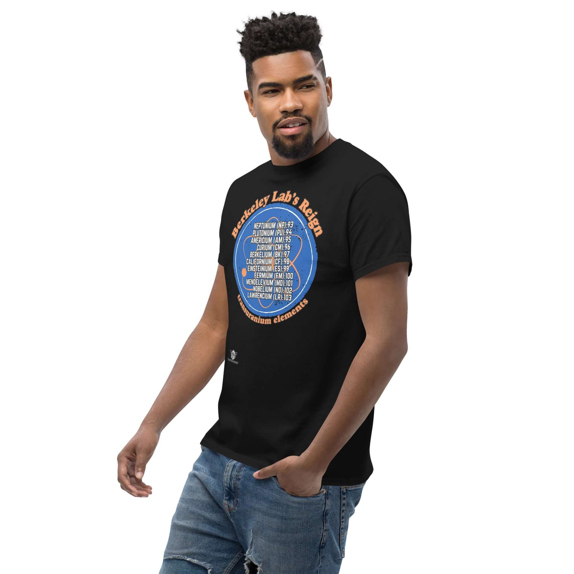 Model wearing Berkeley Lab's Reign Transuranium Elements T-Shirt featuring scientific circle design on black fabric.