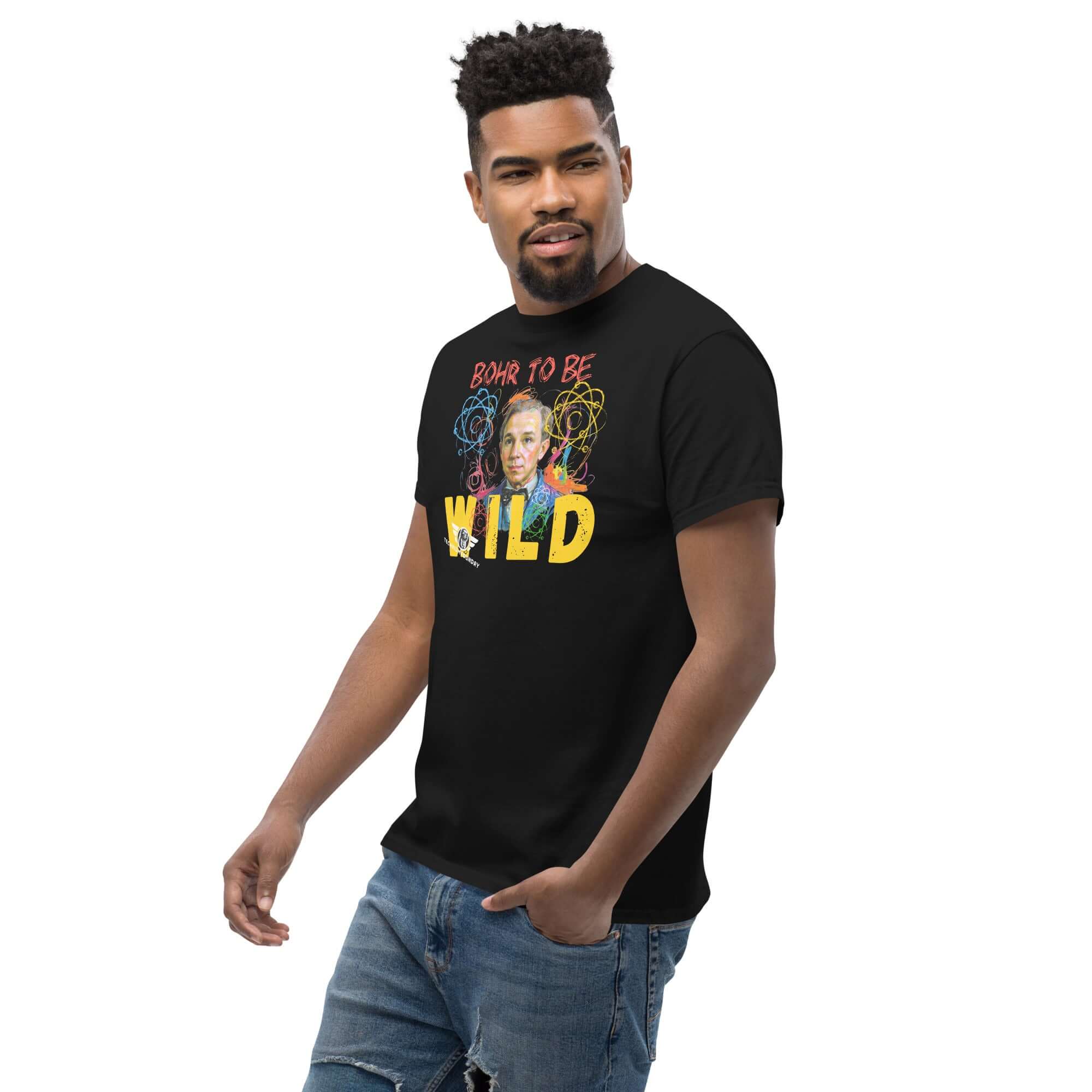 Man wearing a Bohr to Be Wild t-shirt featuring quantum physics art with Niels Bohr's portrait and rock & roll theme.