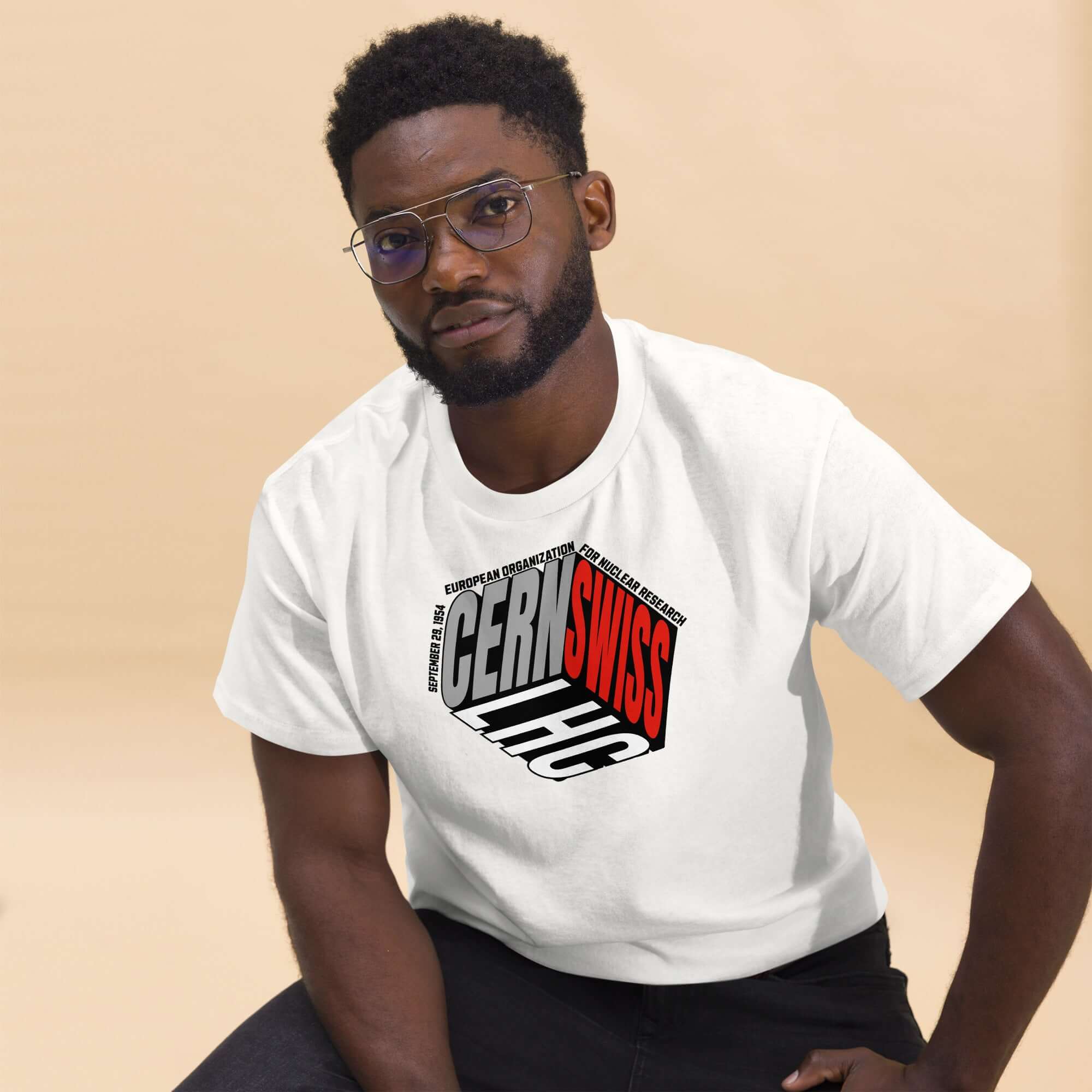 Man wearing a CERN/Swiss Physics Cube T-shirt in olive green, merging fashion with science featuring a reimagined CERN logo