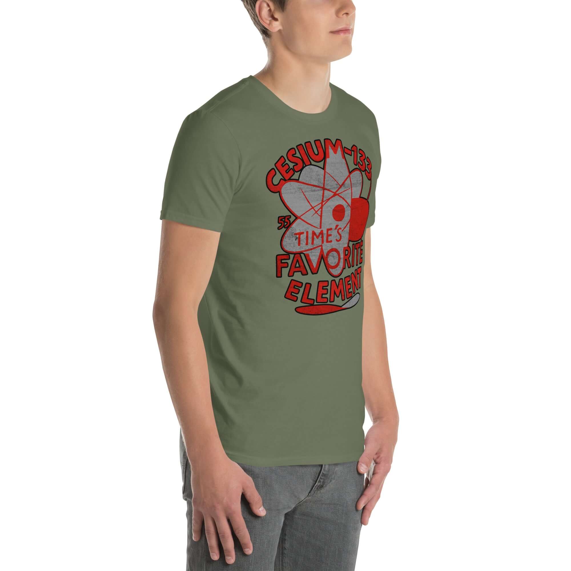 Model wearing Cesium-133 Atomic Clock T-Shirt with quantum design, green color, featuring 'Time's Favorite Element' text.