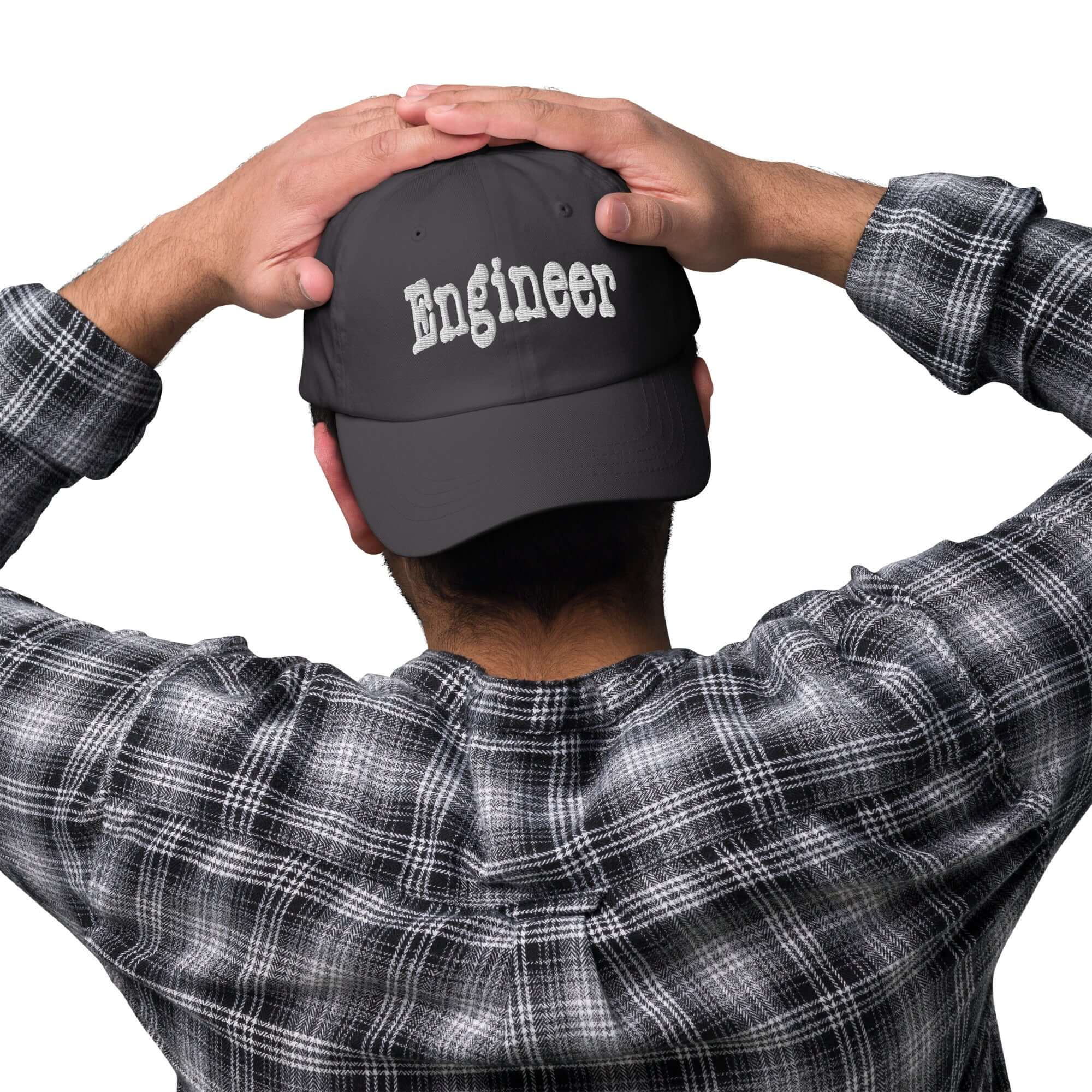 Man wearing 'Engineer' baseball cap, showcasing professional problem-solving headwear in a casual setting.