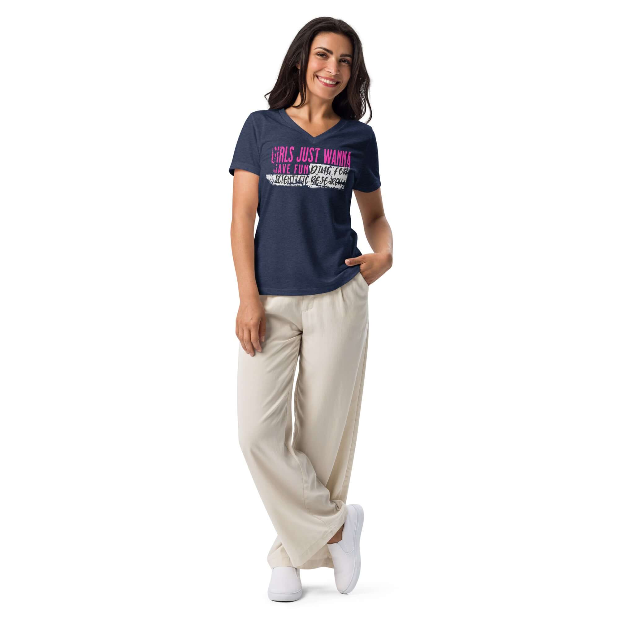 Woman wearing a 'Girls Just Wanna Do Science' T-shirt with pink and black text, standing confidently in casual pants and shoes.
