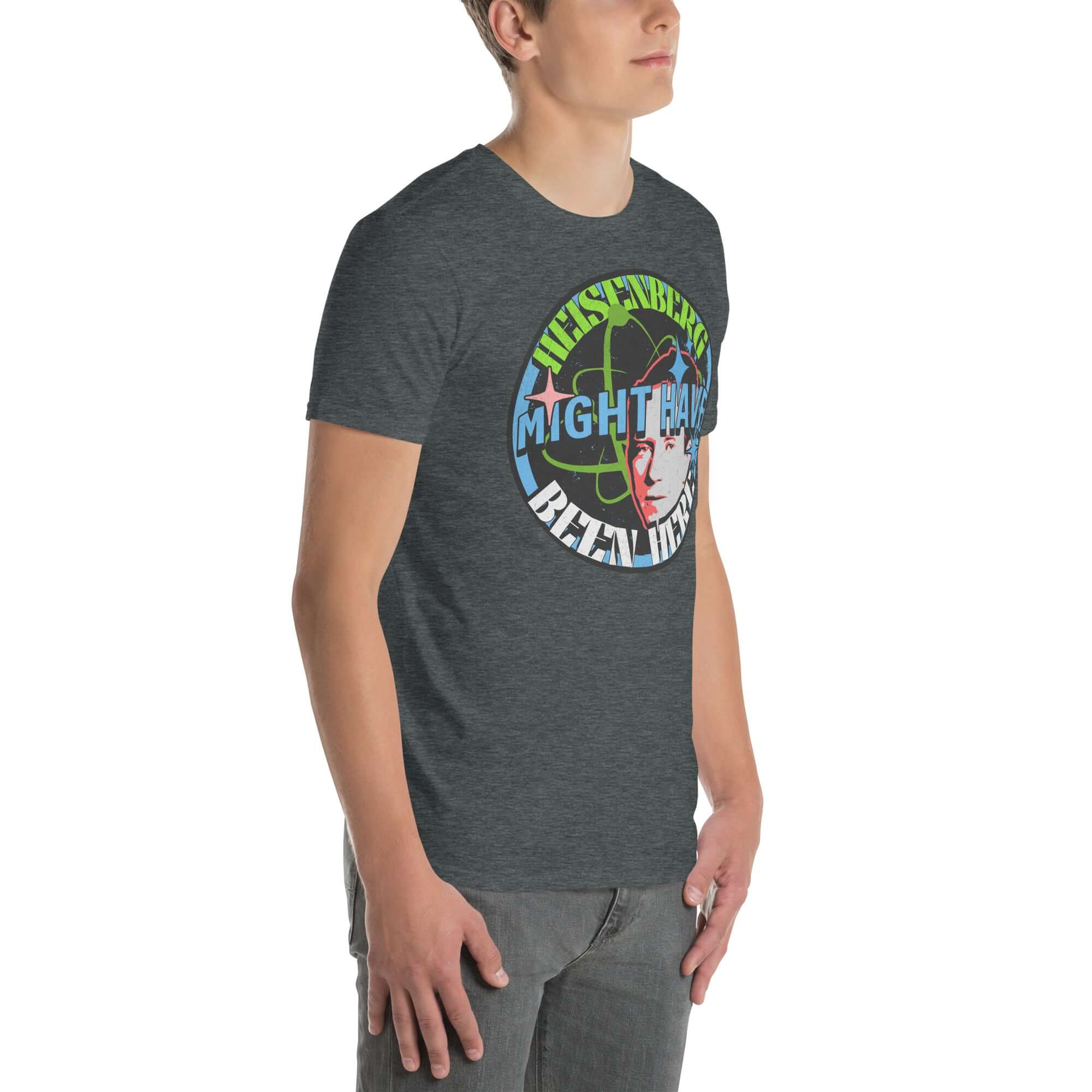 Heisenberg Might Have Been Here T-Shirt with quantum physics humor design and atomic symbols, worn by a man.