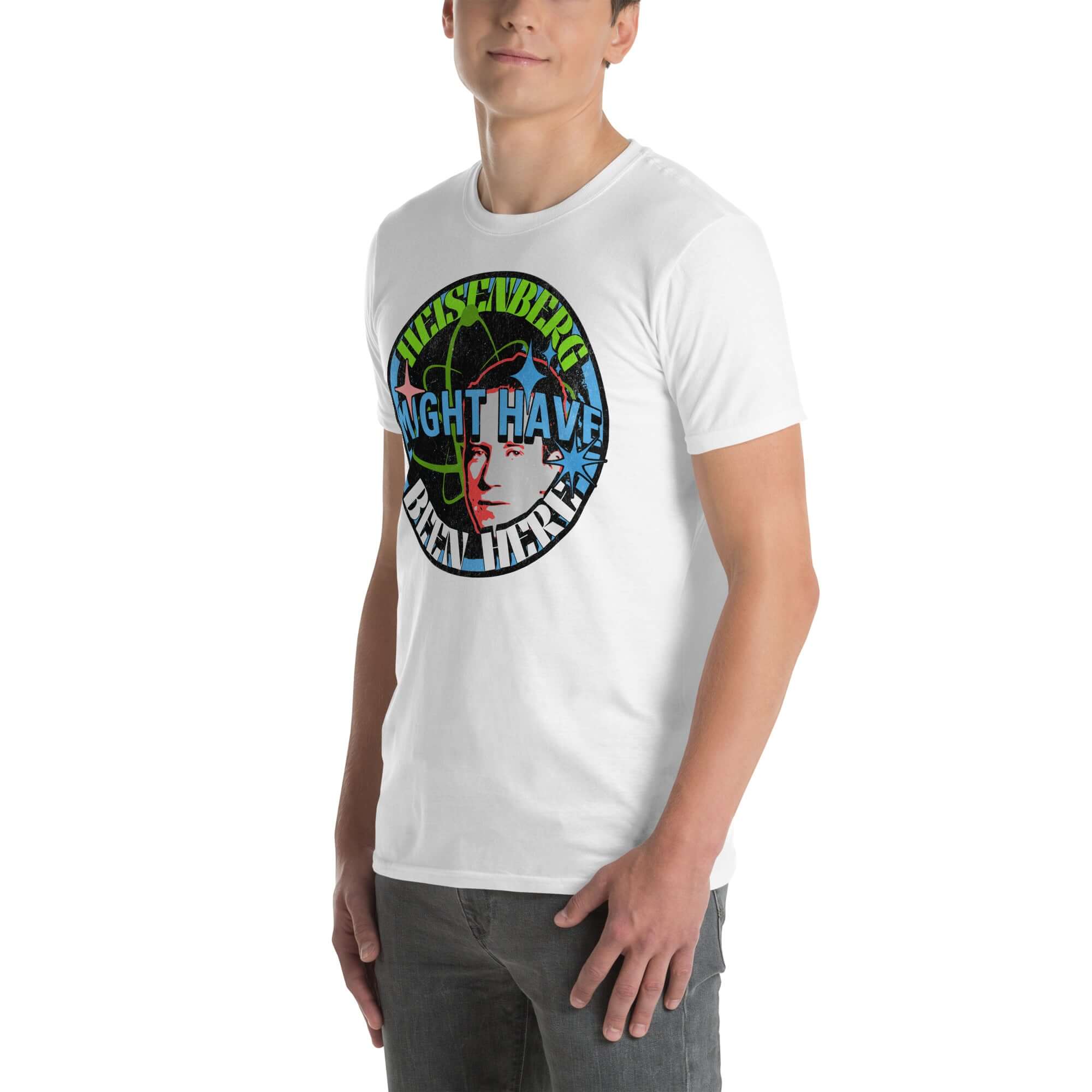 Man wearing 'Heisenberg Might Have Been Here' quantum physics humor t-shirt with atomic symbols and retro design on white tee.