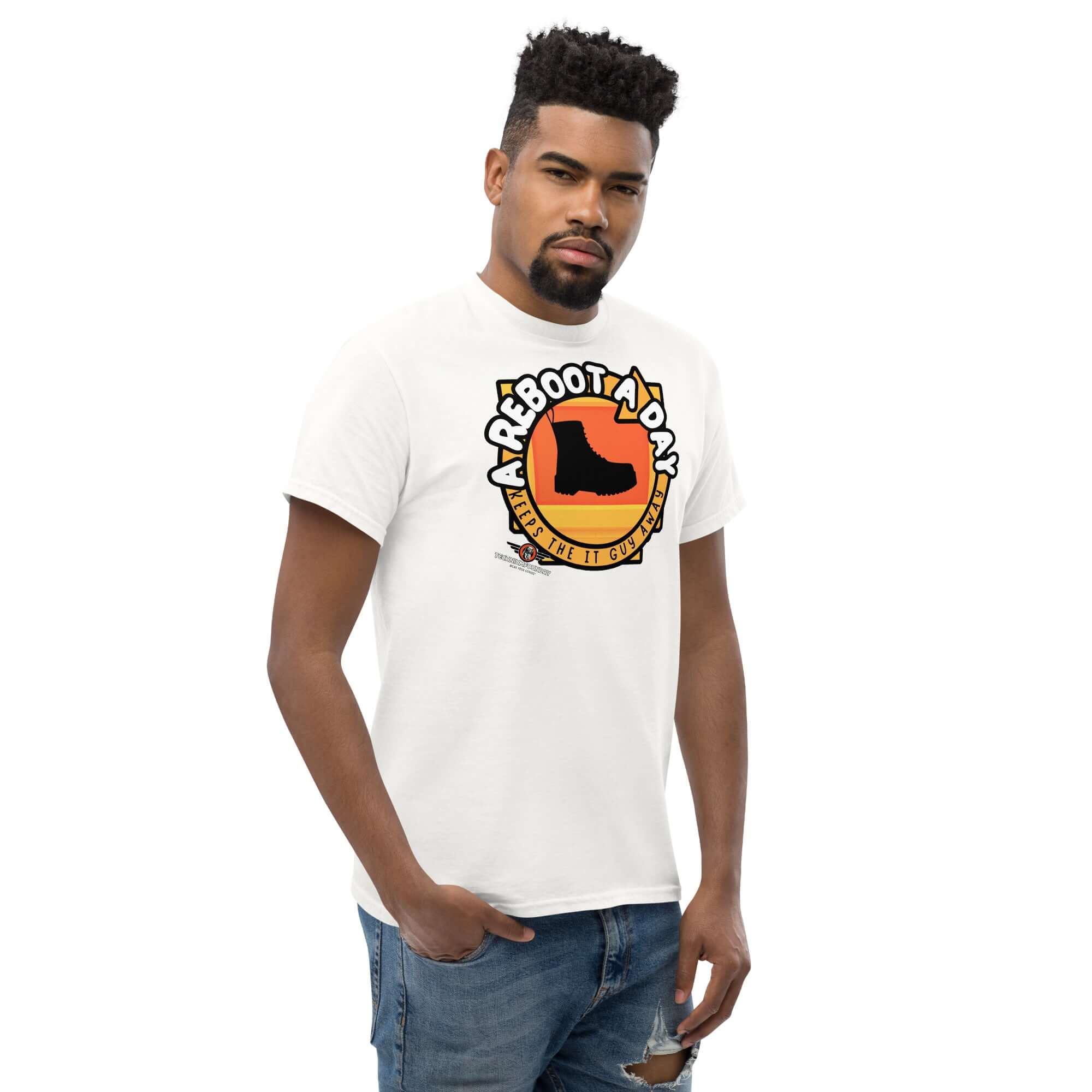 Man wearing 'A Reboot A Day' IT support humor t-shirt with boot design and sunset backdrop.