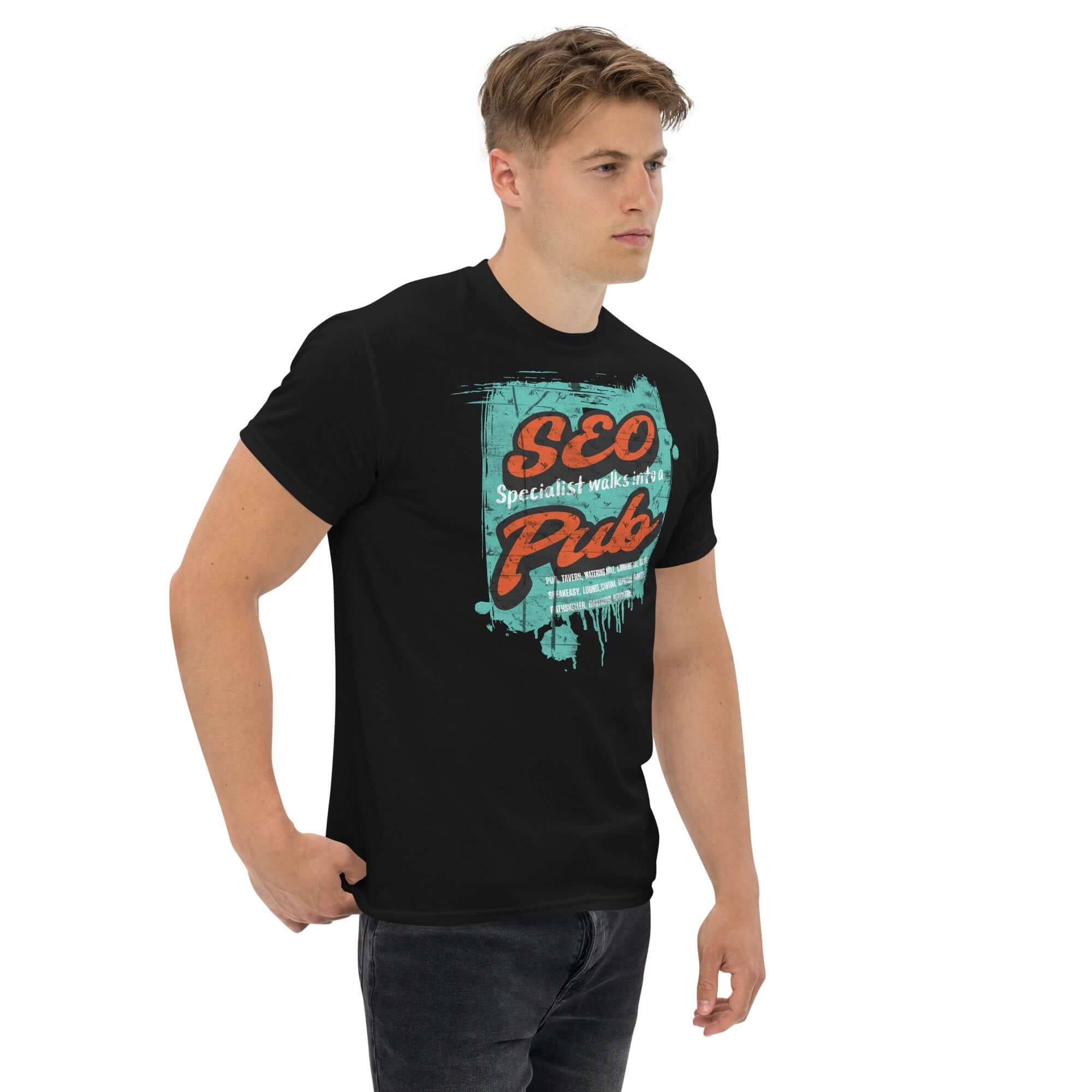 Black "SEO Specialist Walks Into a Pub" t-shirt featuring digital marketing humor, worn by a model, perfect for SEO enthusiasts.