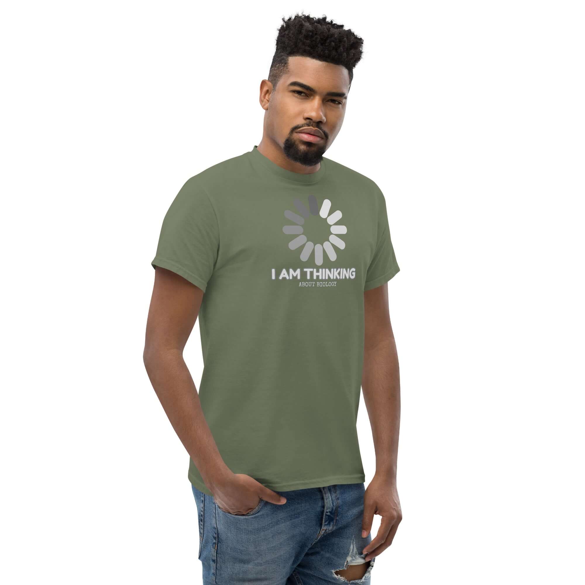 Man wearing olive green 'I Am Thinking About Biology' t-shirt with loading symbol, humor design for science enthusiasts.