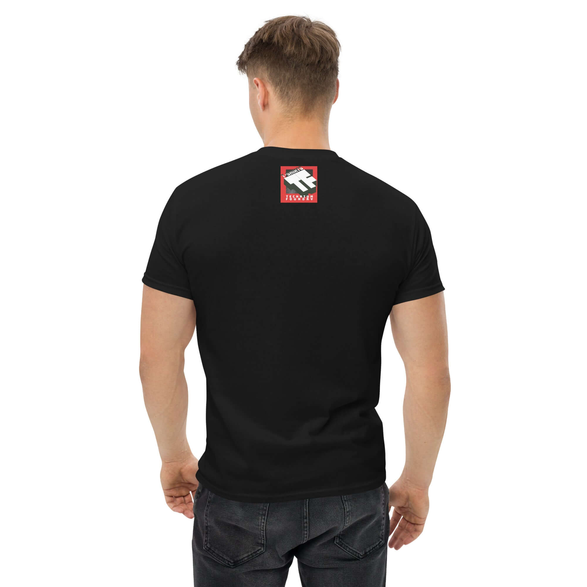 Man wearing black t-shirt with a minimalist design on the back, featuring bold colors and an adventure-themed logo.