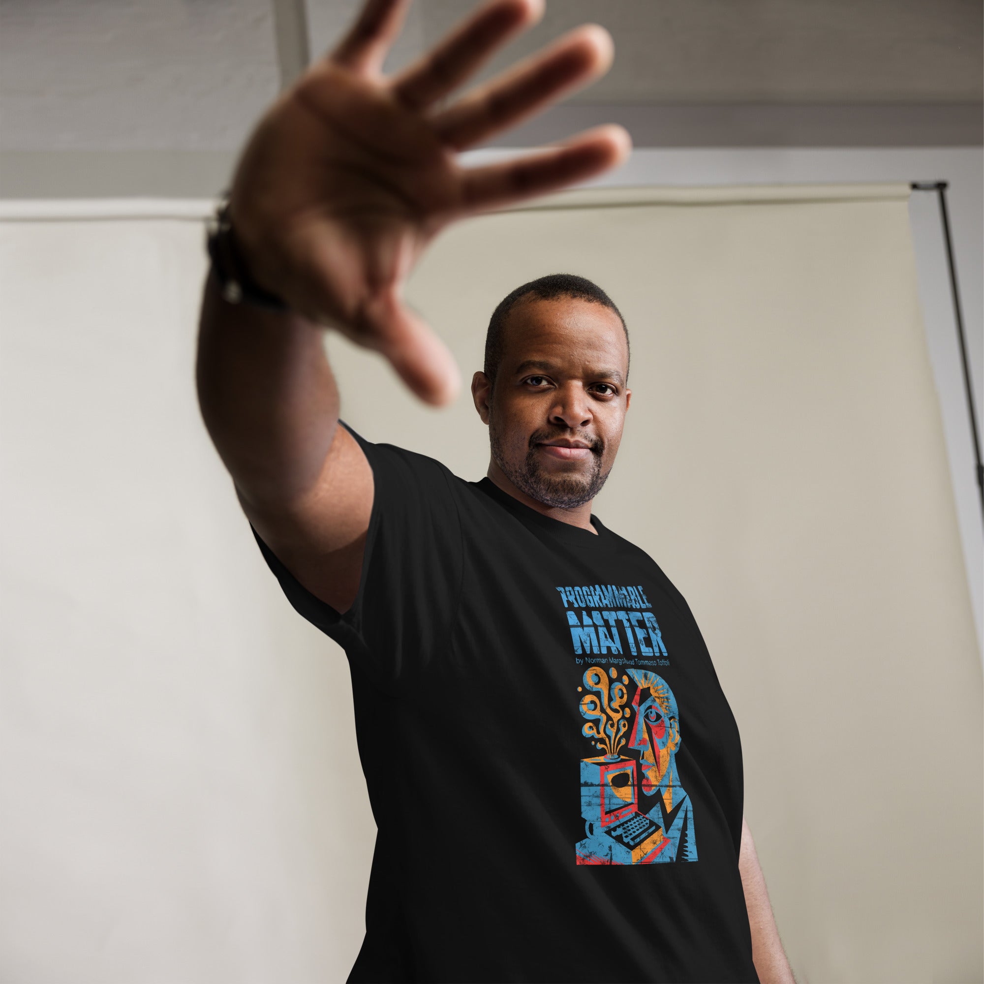 Man wearing "Computronium Programmable Matter" t-shirt with theoretical physics design and starburst pattern.
