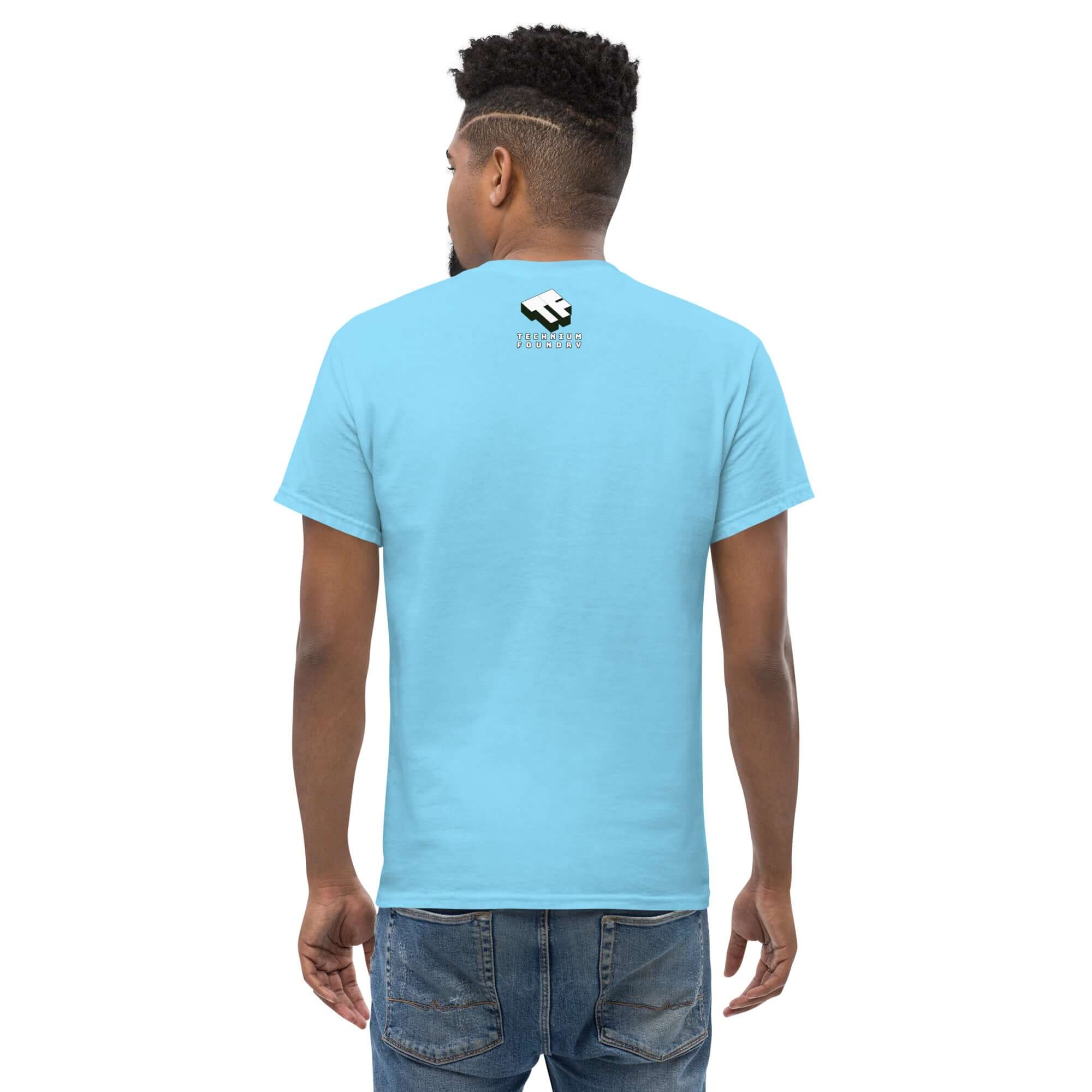 Back view of a person wearing a blue Starfish Prime T-shirt with a retro nuclear space test design logo.