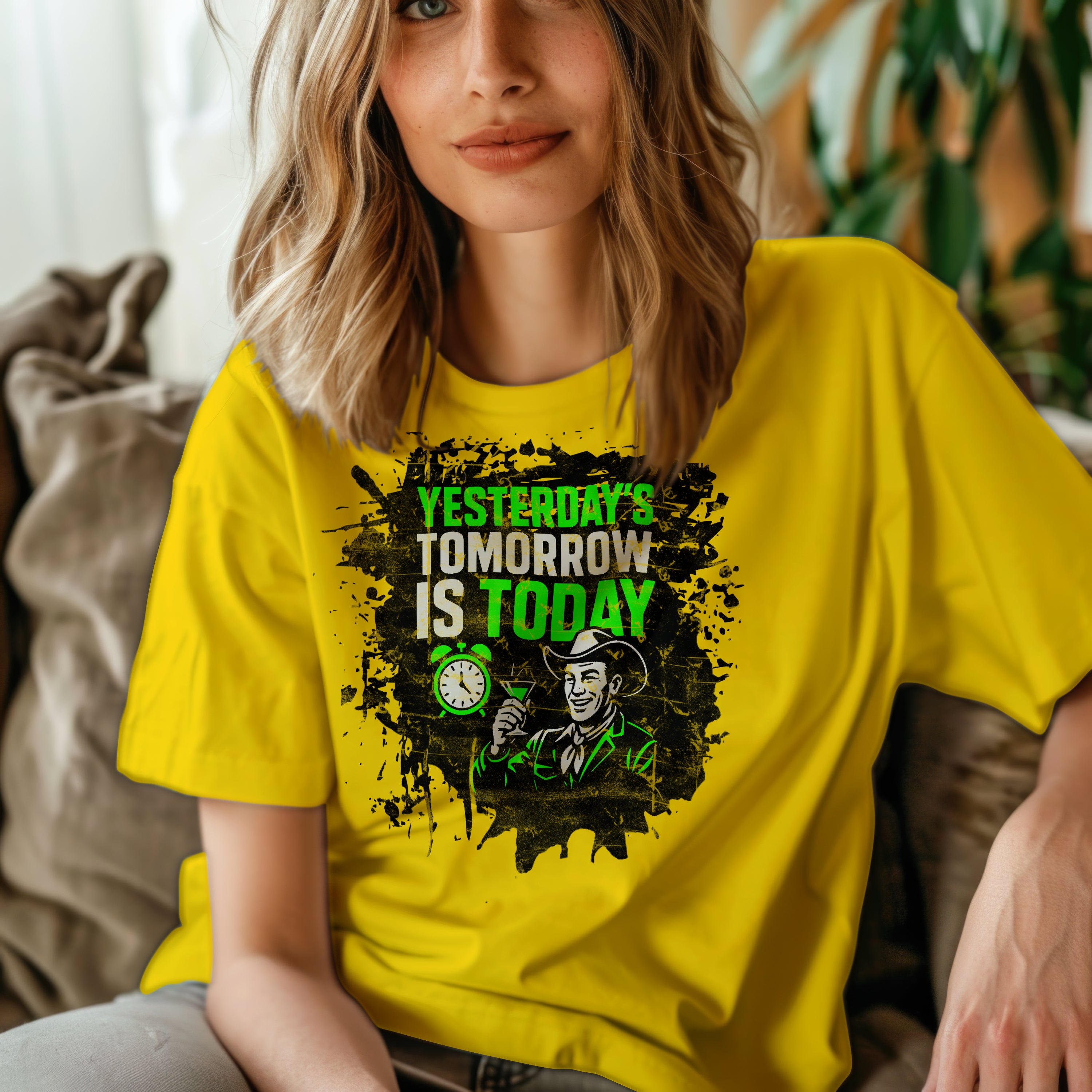 Woman wearing "Yesterday's Tomorrow Is Today" dystopian t-shirt with industrial design, sitting on a couch.