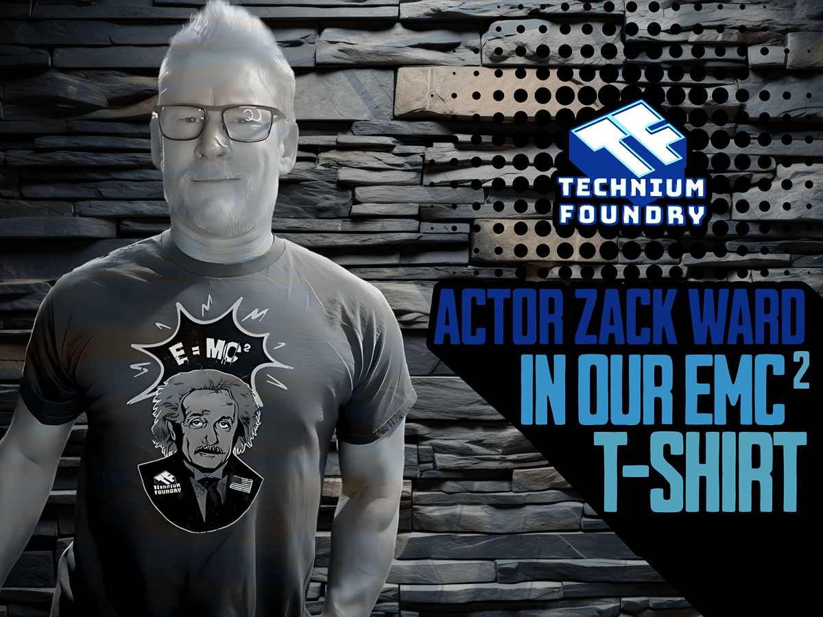 Person wearing Technnium Foundry EMC² T-shirt with Einstein graphic against a modern stone wall backdrop.