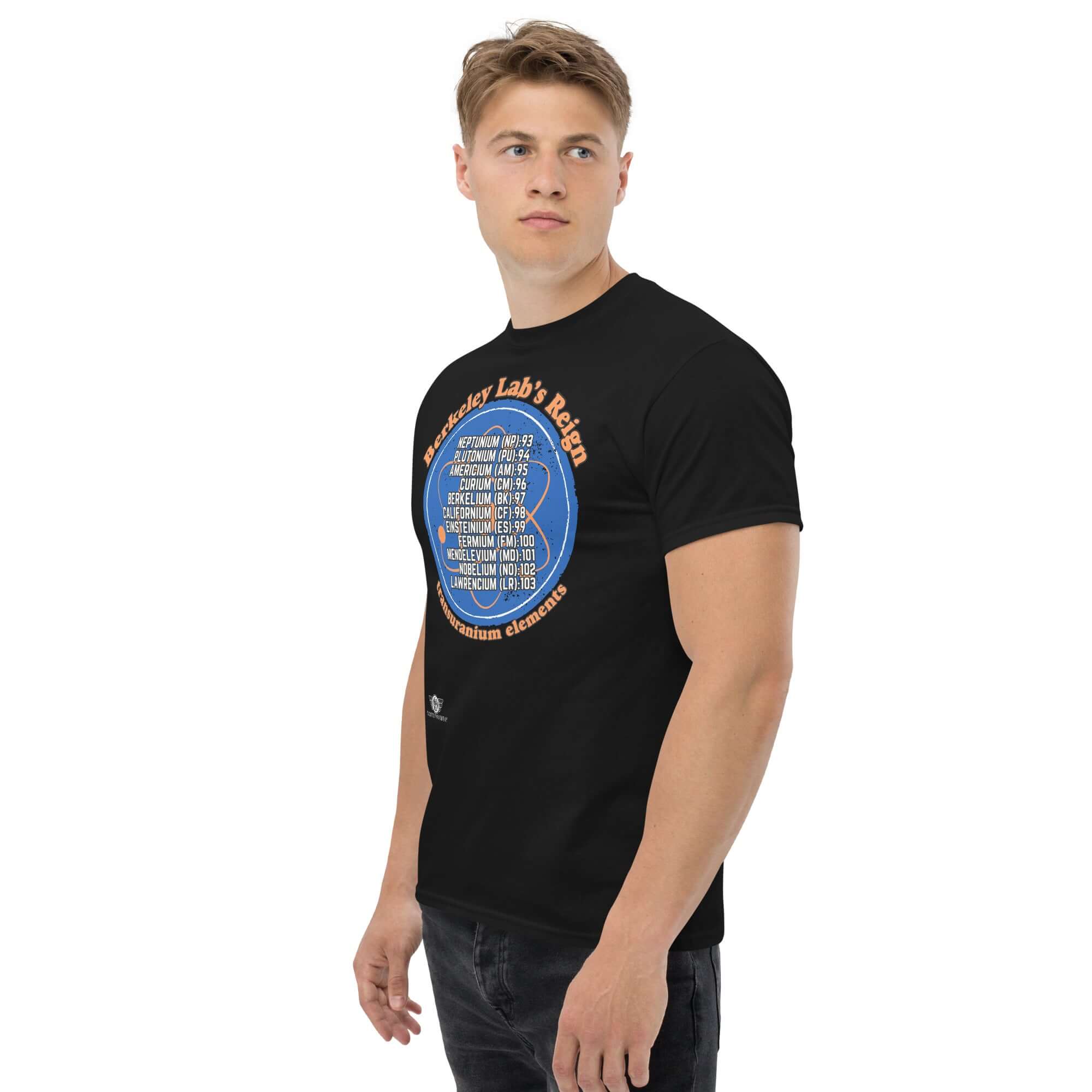 Man wearing Berkeley Lab Reign Transuranium Elements T-Shirt with blue circular design and white text on black fabric.