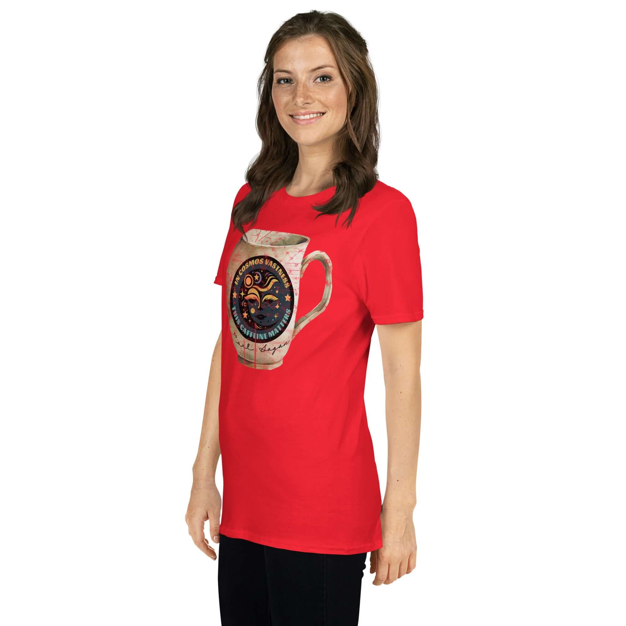 Person wearing a red t-shirt with a Carl Sagan Cosmic Coffee Mug design, featuring a celestial motif with stars and a lunar face, promoting caffeine humor.