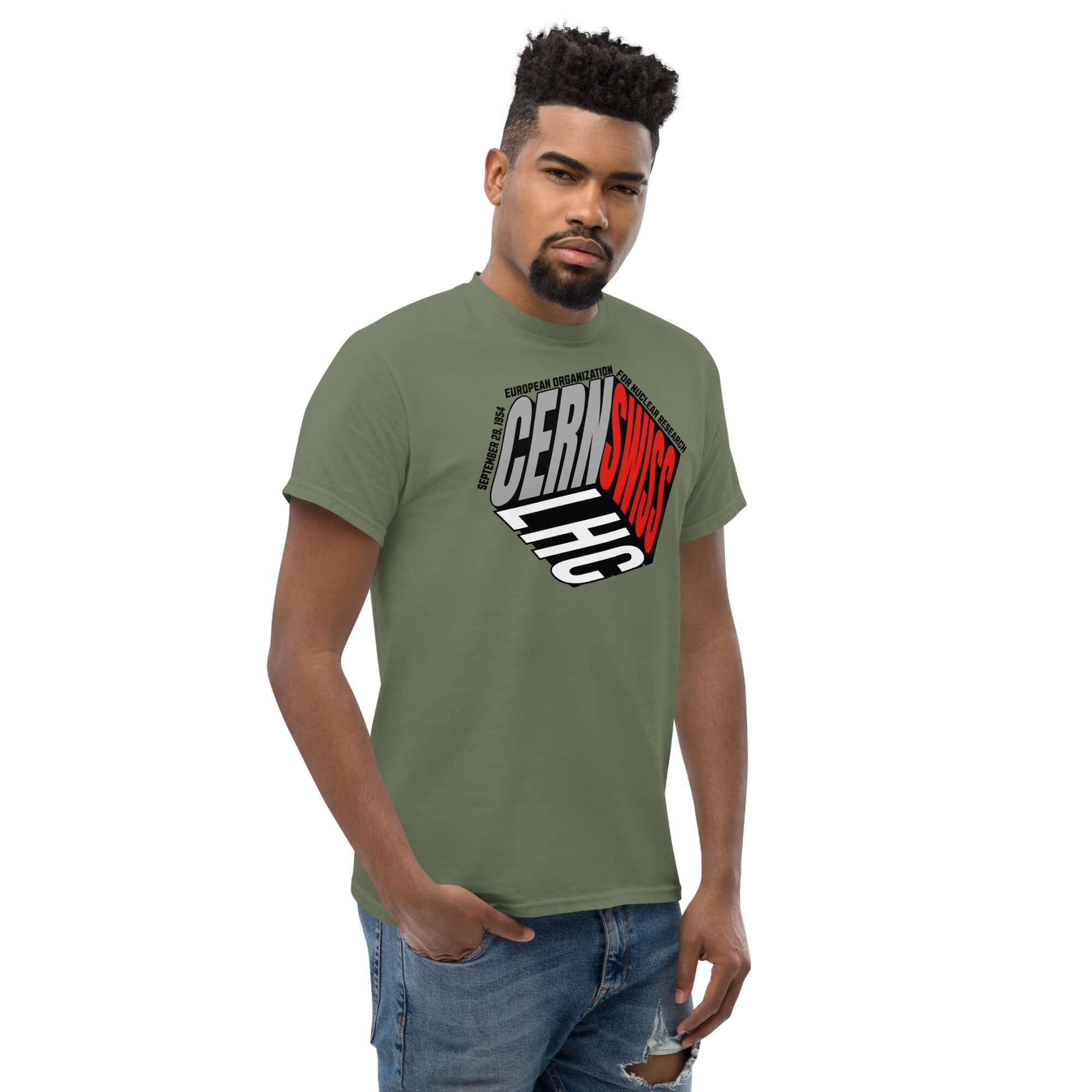 Olive-green CERN Swiss Physics Cube T-Shirt featuring a reimagined CERN logo, worn by model. Perfect for science and fashion enthusiasts.