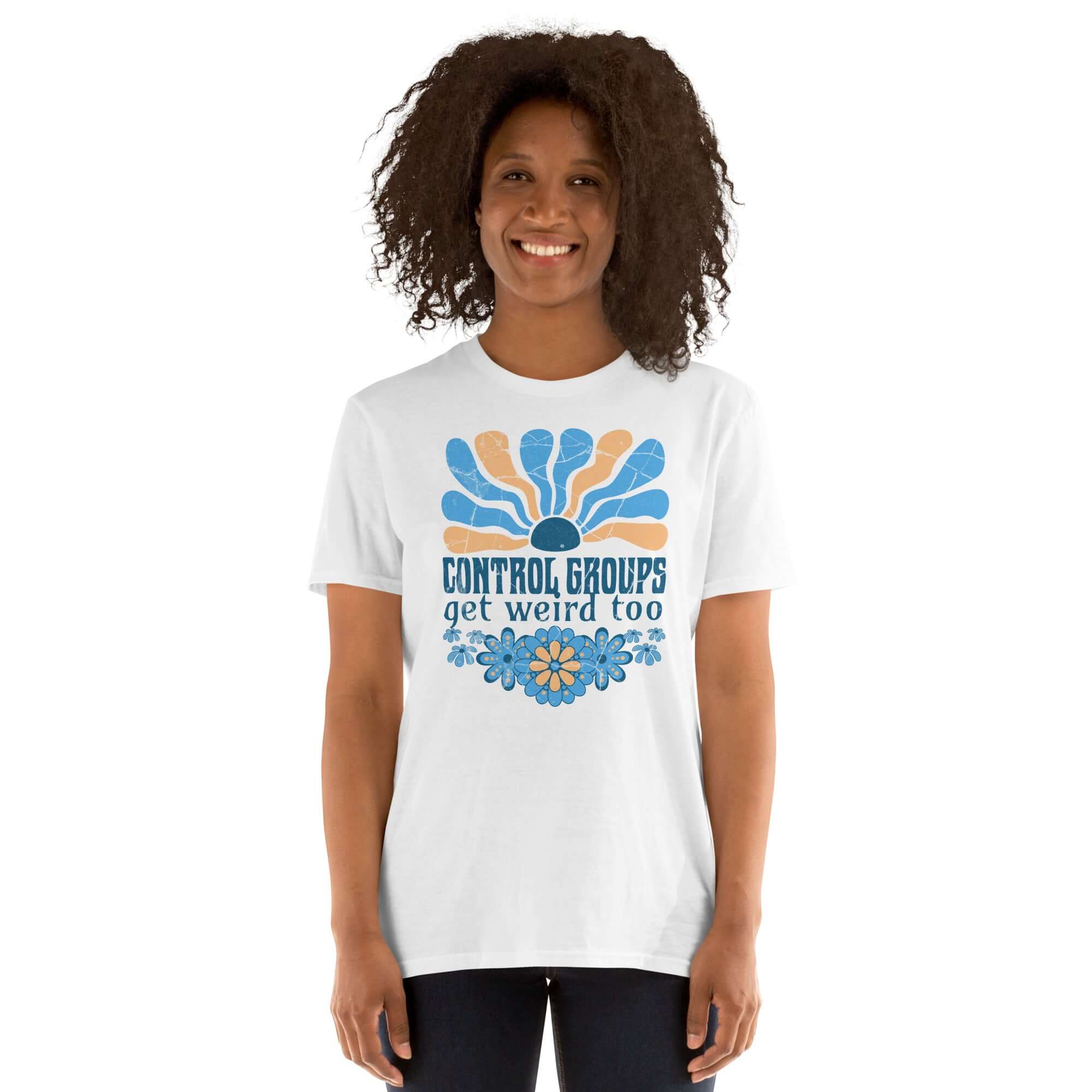 Retro science humor t-shirt with 'Control Groups Get Weird Too' design, featuring a 70s-inspired blue and orange sunburst graphic.