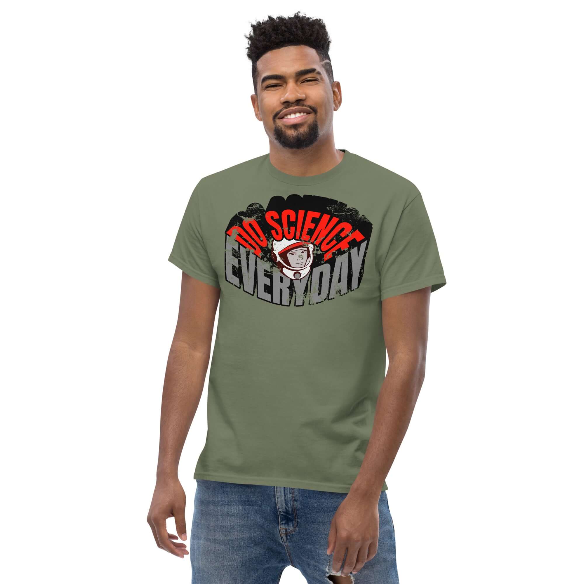Man wearing Do Science Every Day T-Shirt with retro astronaut design on green cotton fabric.