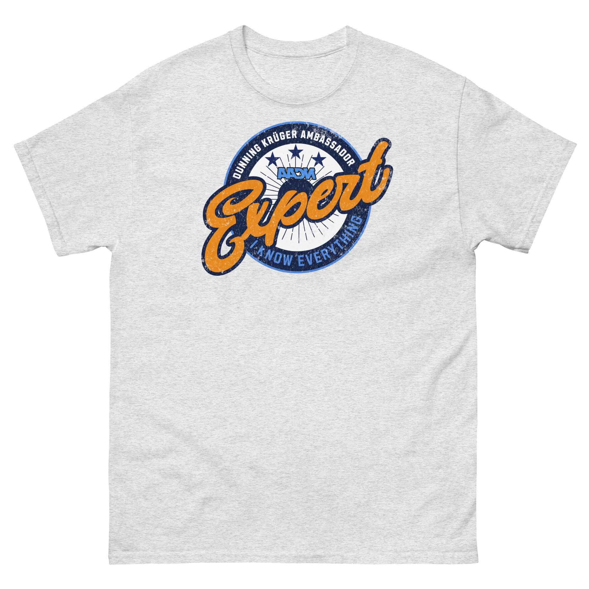 Olive green t-shirt with 'Dunning-Kruger Ambassador: Expert At How Everything Works' emblem, resembling a sports team logo.