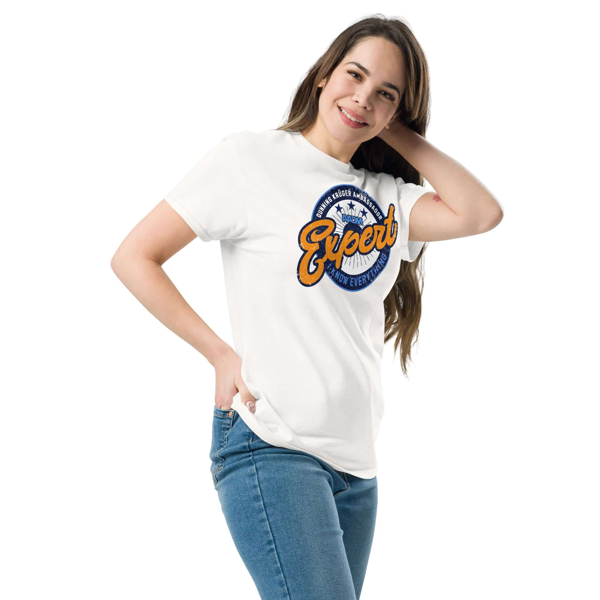 Woman posing in white Dunning-Kruger Expert T-shirt with sports logo style emblem, perfect for fans of amateur psychology and irony.