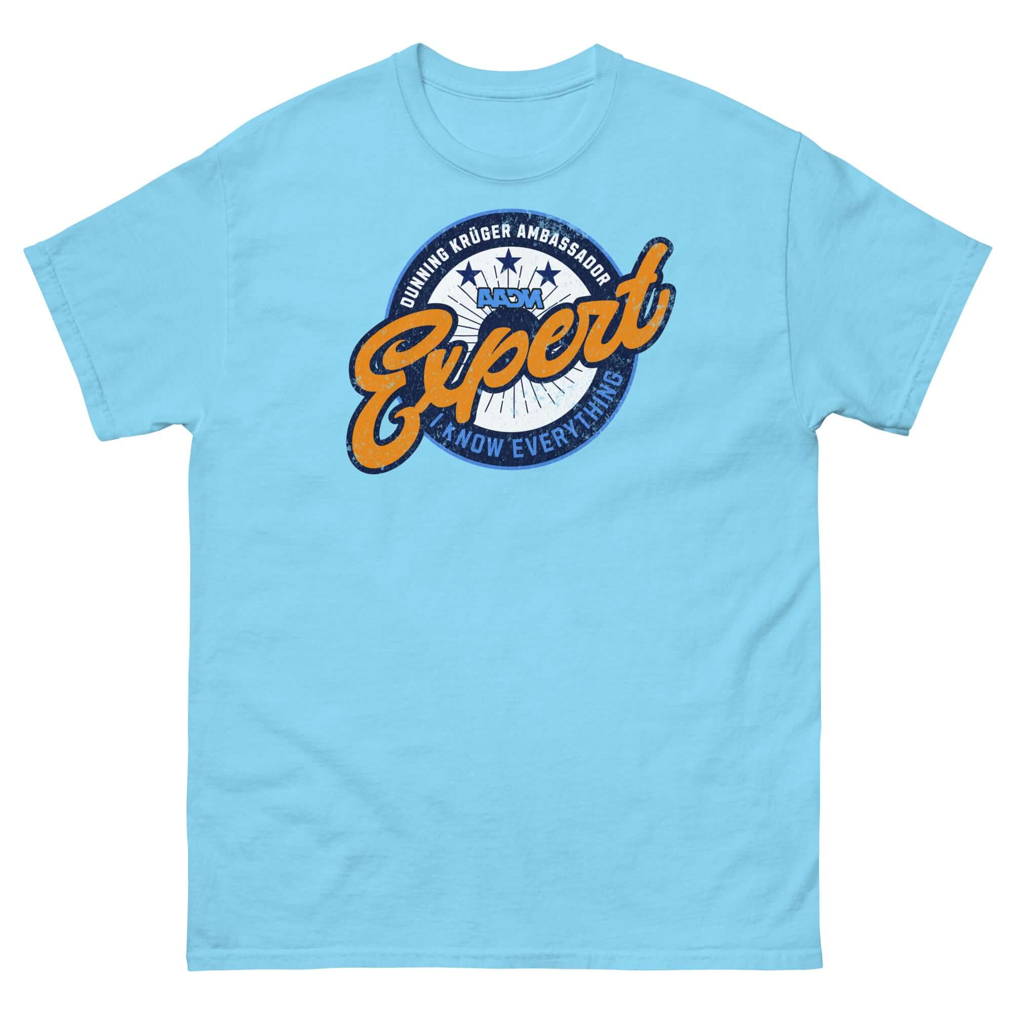 Light blue t-shirt featuring 'Dunning-Kruger Ambassador: Expert At How Everything Works' emblem, styled like a sports team logo.