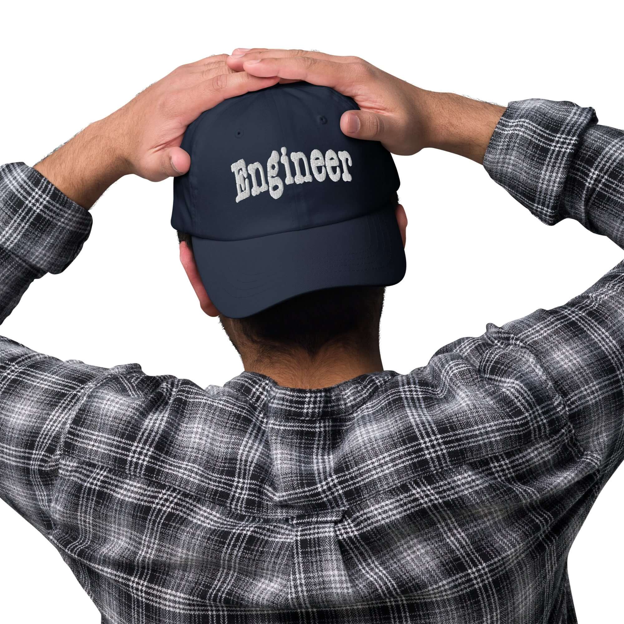 Person wearing Engineer baseball cap, showcasing professional problem-solving headwear.