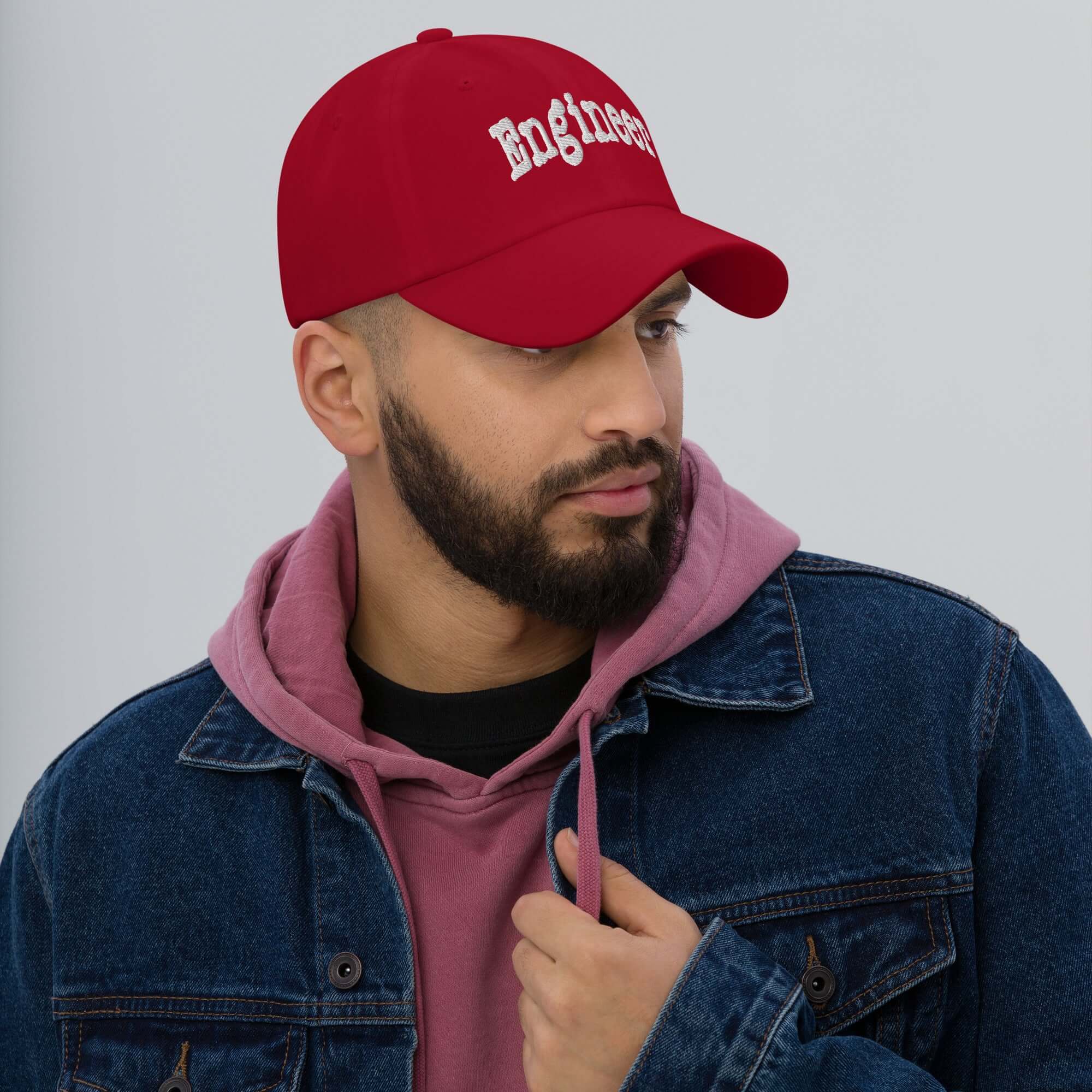 Stylish engineer wearing a red "Engineer" baseball cap, symbolizing problem-solving prowess and professional skill, ideal for engineers.
