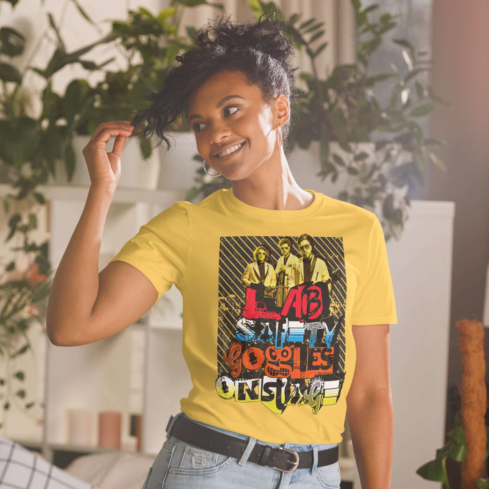 Woman wearing a Lab Safety Goggles Onstage T-shirt with science rock band design, blending safety and arena rock style.