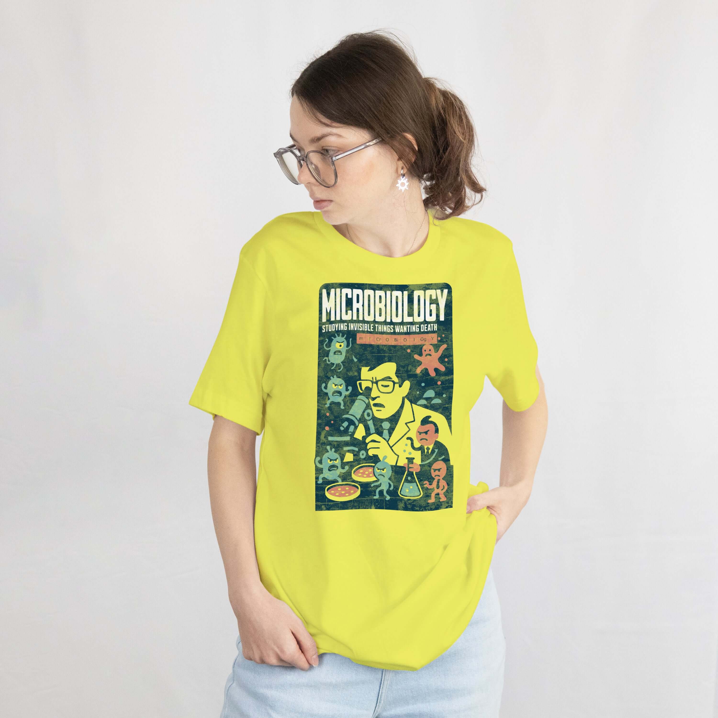 Woman wearing Microbiology T-Shirt with comic design featuring scientist and microorganisms.