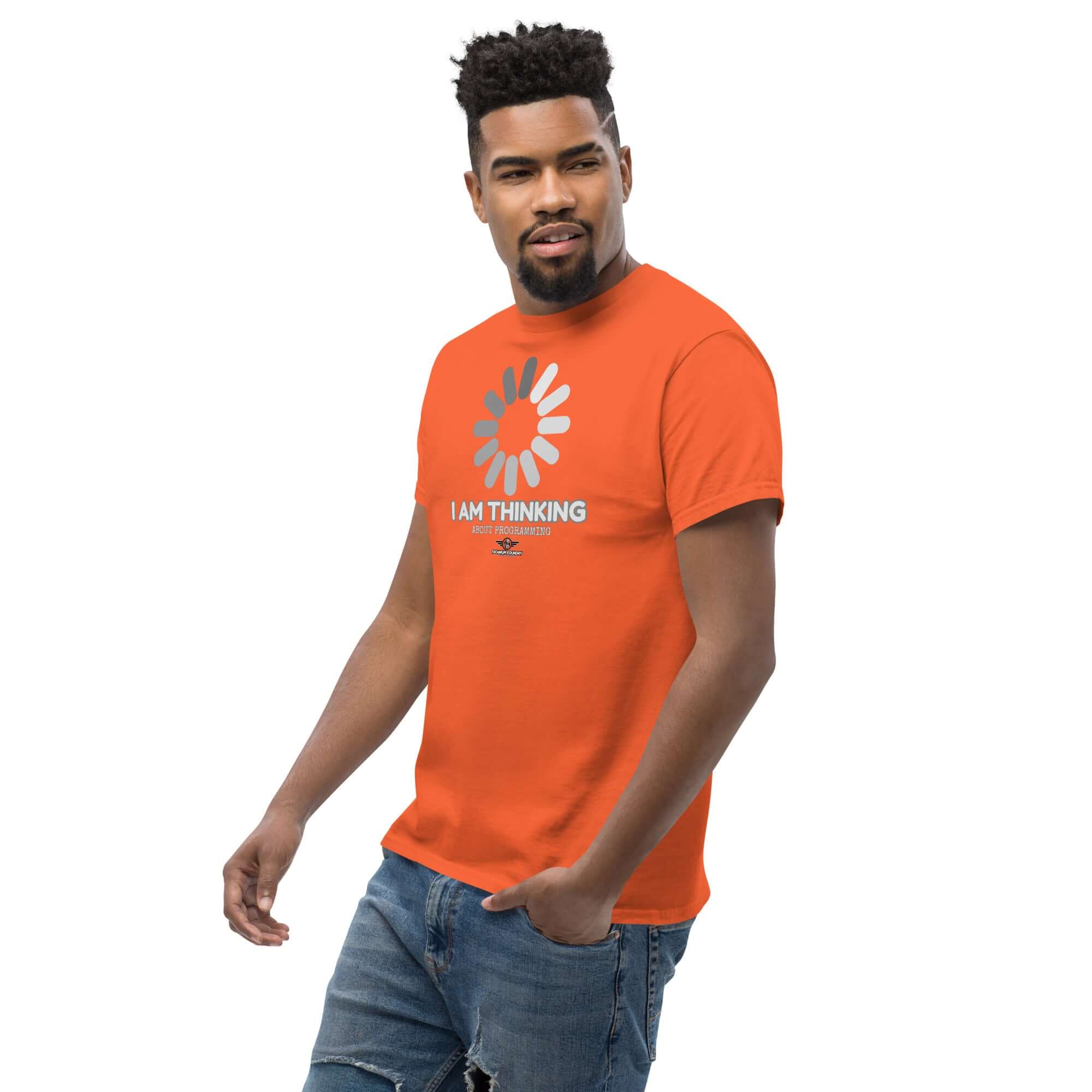 Man wearing orange 'I Am Thinking About Programming' T-shirt with loading screen design. Ideal for coders; combines humor with tech flair.