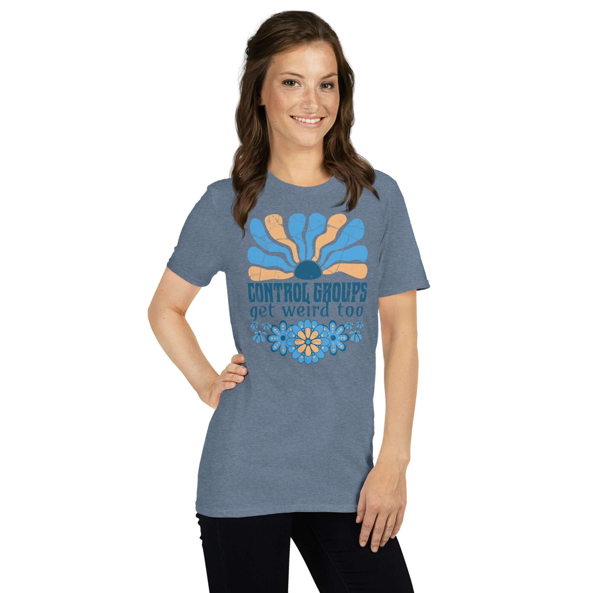 Woman wearing a 'Control Groups Get Weird Too' t-shirt with retro blue and orange sunburst design, adding humor to science apparel.