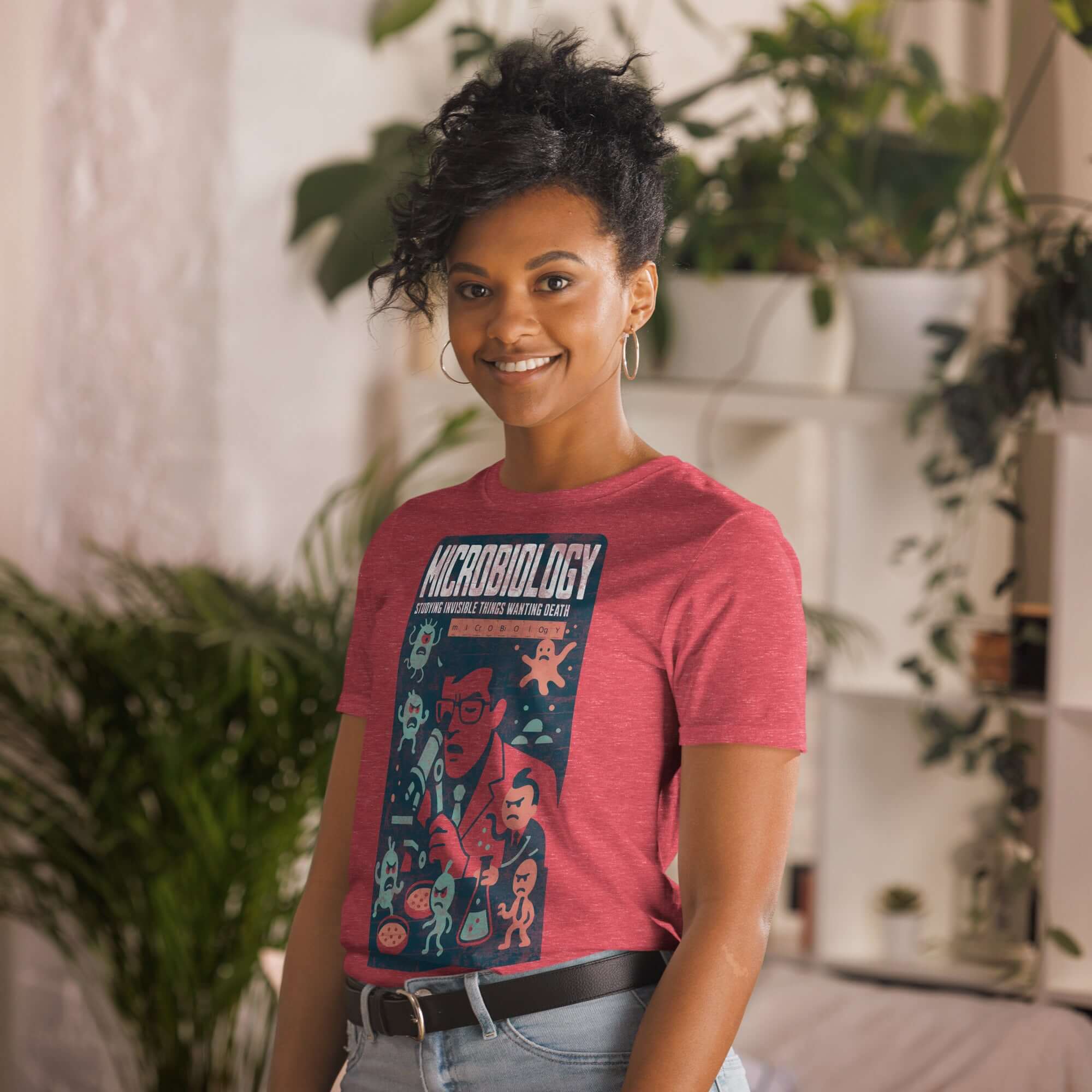 Woman wearing a red 'Microbiology: Studying Invisible Things Wanting Death' t-shirt, featuring a science-themed graphic design.